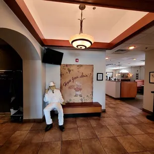a man sitting on a bench in a hotel lobby