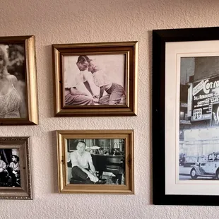 a couple of old photos hanging on a wall