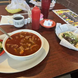 Barbacoa taco and bowl of loaded Menudo