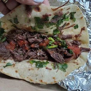 Barbacoa taco with salsa.