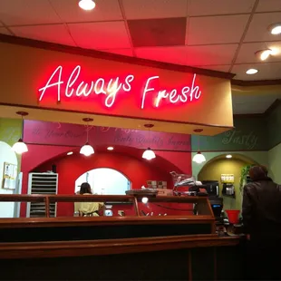 a neon sign above the counter