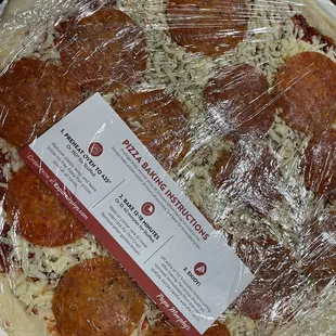 a pizza wrapped in plastic wrap