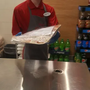 a young man holding a tray of food