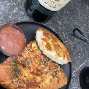 a plate of food and a bottle of wine