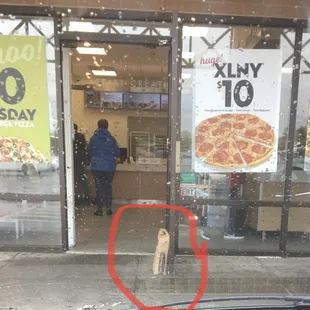 Used pizza crust bag set on concrete outside to prop front door open! Yikes!!