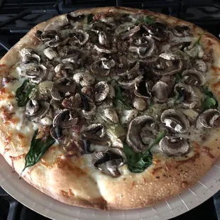 Cooked  chicken bacon artichoke regular crust with added mushrooms.