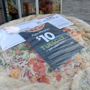 a pizza wrapped in plastic