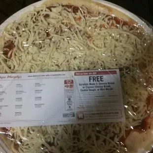 a pizza wrapped in plastic