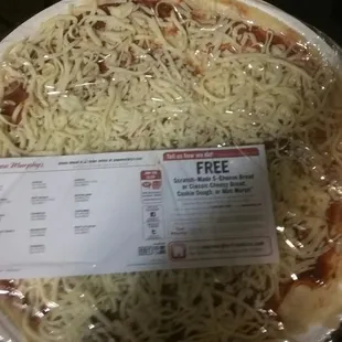 a pizza wrapped in plastic