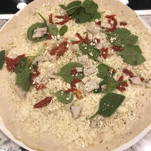 a pizza with spinach and cheese