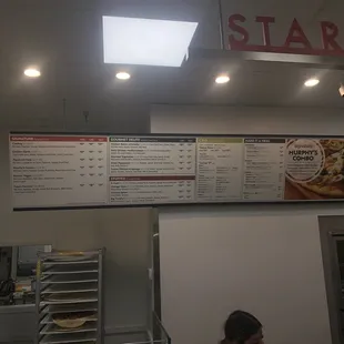 a menu and a sign above the counter