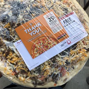 a pizza wrapped in plastic