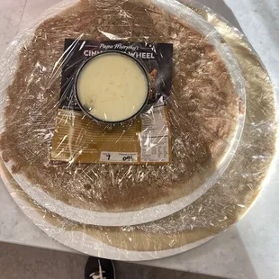 a pizza wrapped in plastic wrap