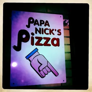 a hand holding a pizza