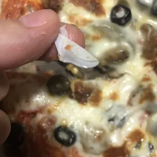 Piece of plastic in the pizza(they told me it was invalid since it was a wrong order but still very gross)