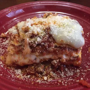 a piece of lasagna on a red plate