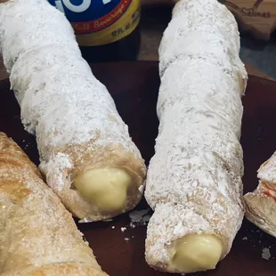 Tornillos - puff pasty with Bavarian cream, topped with powdered sugar.
