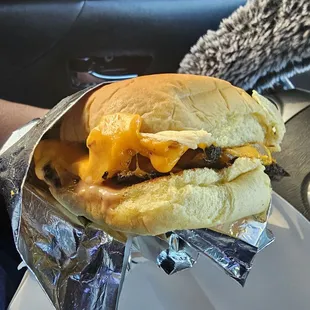 Hamburger with cheese bomb grilled onions