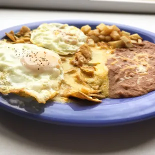 Los Chilaquiles (chee-law-key-less).  Two eggs served on lightly fried corn tortillas strips smothered in green or red Anaheim Pepper sauce.