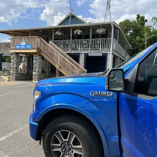 a blue truck parked in a parking lot