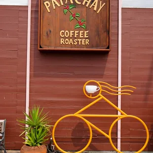 a bicycle parked in front of a coffee roaster