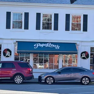 two cars parked in front of the restaurant