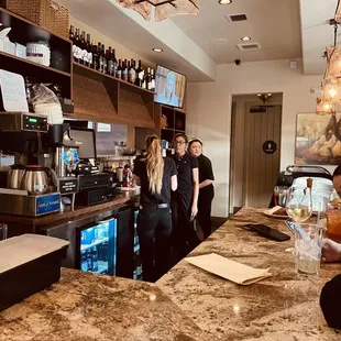 a group of people standing at a bar