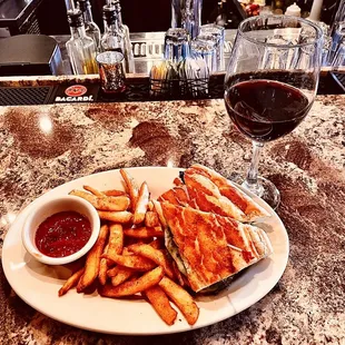 a plate of food and a glass of wine