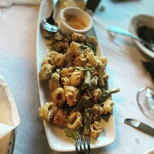Lightly fried calamari. The best awesome sauce too. Our favorite..!!