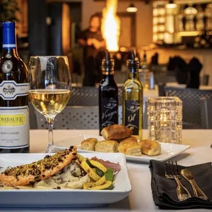 a plate of food and a glass of wine