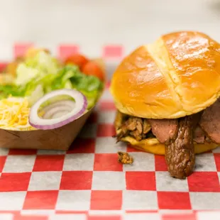a pulled pork sandwich and a side salad