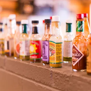 a row of bottles of hot sauce