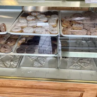 a variety of donuts in a display case