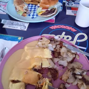 Cheese burger and seasoned fries, turkey club omelette with home fries.