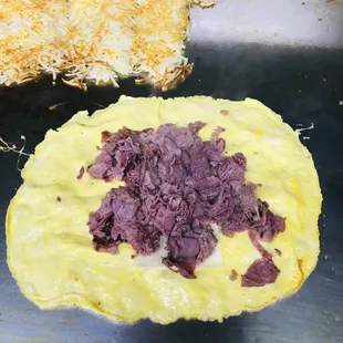Corned beef omelette with Swiss cheese Hashbrowns or Grits toast and Jelly