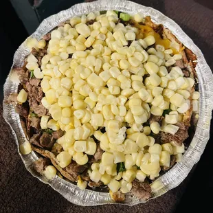 Asada potato with butter, sour cream, cheese, jalapeños, chives, and corn.