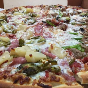 Eat in or pick up! Large half sausage bell pepper mushroom/pineapple ham jalapeño YUM! :)'