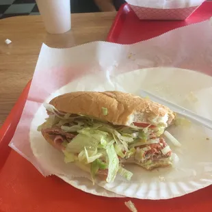 a sub sandwich on a paper plate