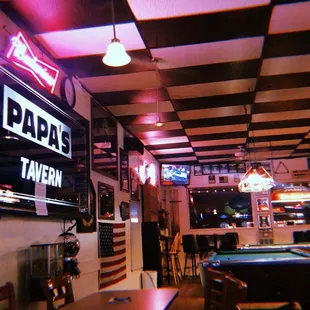 a pool table and neon signs