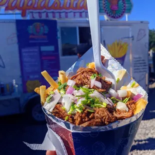 a person holding a container of food