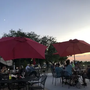 people sitting under umbrellas