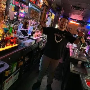 a man standing in front of the bar