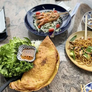 Vietnamese Crepe Wok noodle with chicken Grilled Prawns Papaya Salad