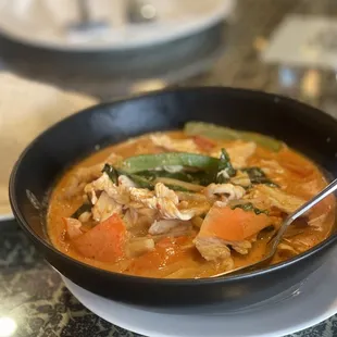 a bowl of soup and a plate of rice