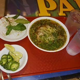 a plate of noodles and a bowl of soup