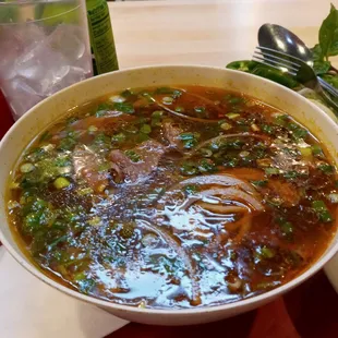 a bowl of soup and a glass of water