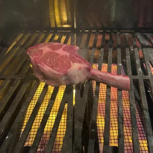 a piece of meat cooking on a grill