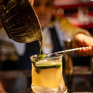 a bartender pouring a drink