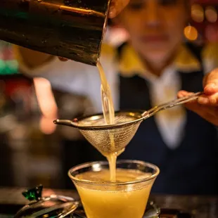 a bartender pouring a drink