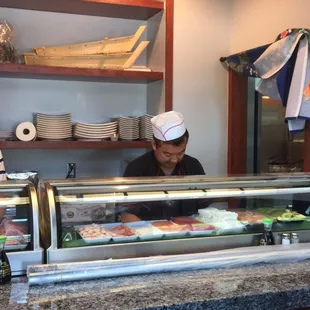 two men preparing sushi